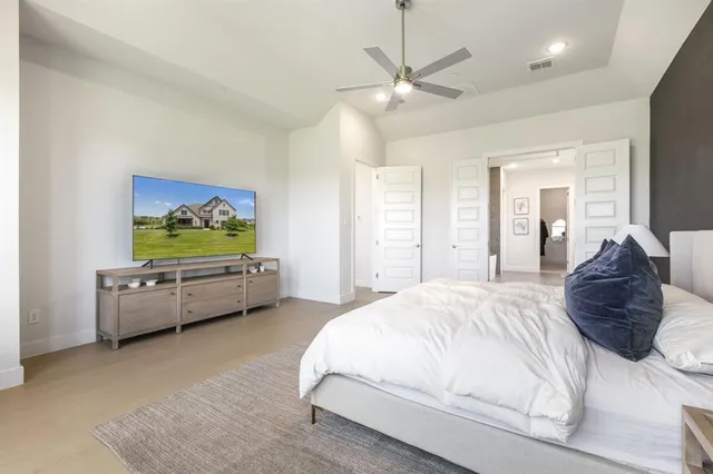 a spacious bedroom with a bed and a couch