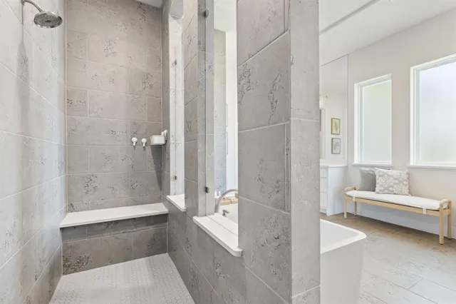 a bathroom with a tub shower and sink