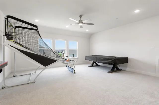 a living room with furniture and a ceiling fan