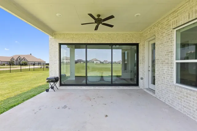 a view of a livingroom with a floor to ceiling window and an outdoor kitchen