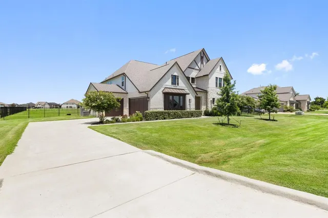 a front view of house with yard and green space