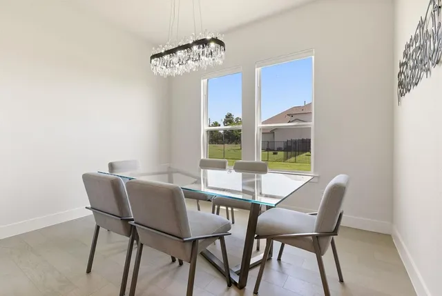 a view of a dining room with furniture wooden floor and a chandelier