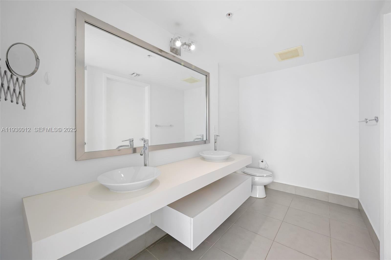 92 Southwest 3rd Street, Unit 3902 Miami, FL 33130 - Photo 8 of 21 a bathroom with a sink and a mirror