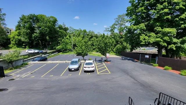 a view of a patio with a table and chairs under an umbrella