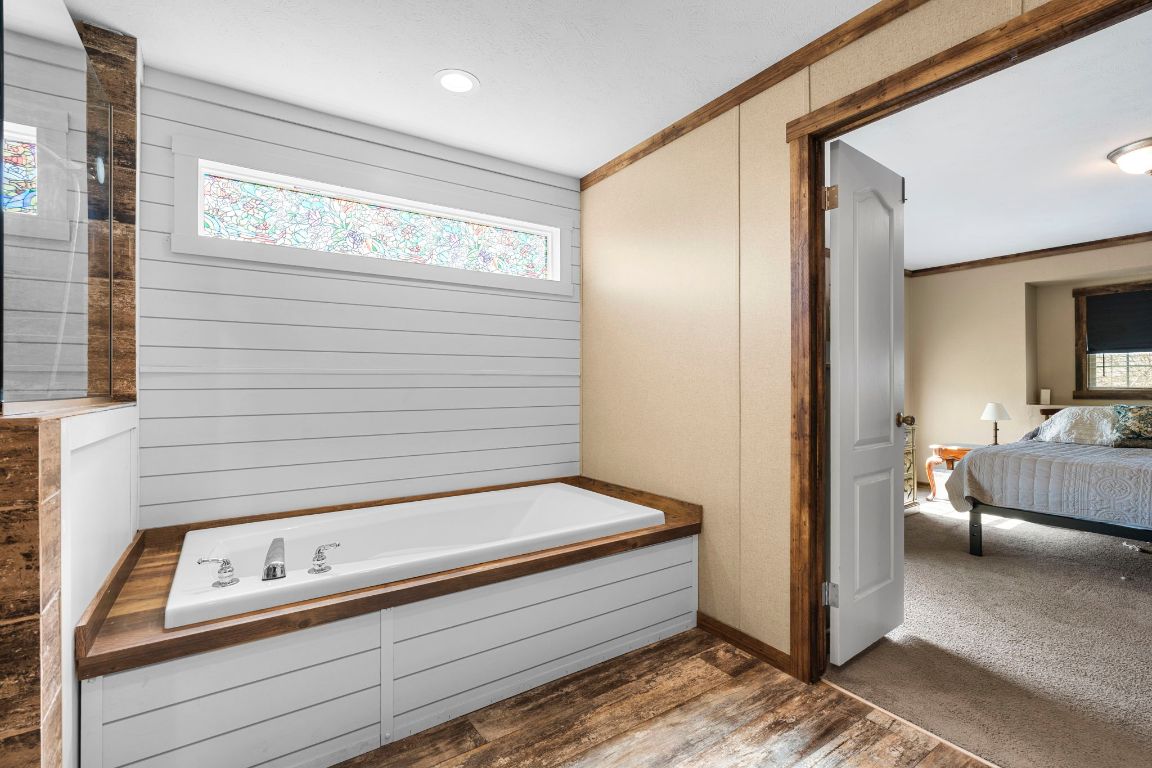 498 William Pettus Road Maxwell, TX 78656 - Photo 14 of 27 a bathroom with a bathtub and a shower