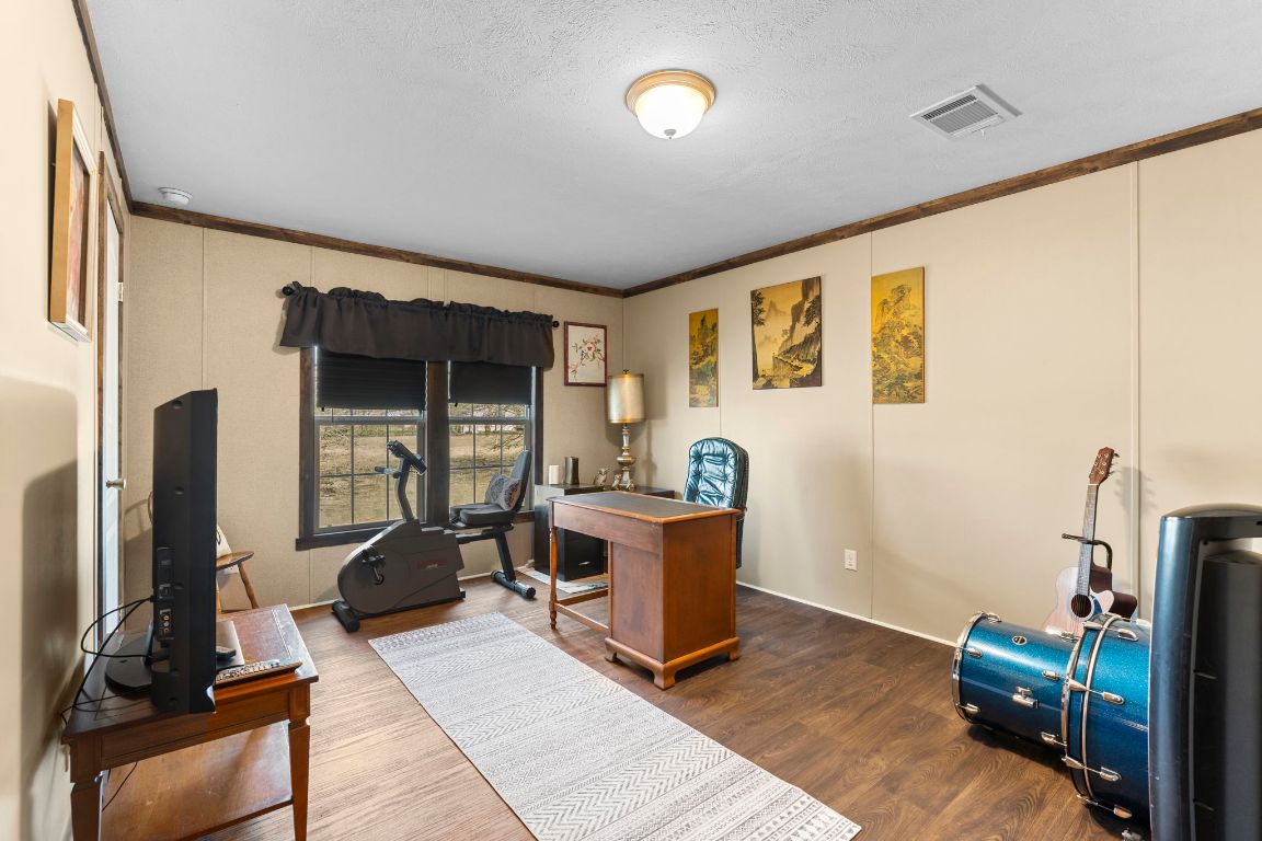 498 William Pettus Road Maxwell, TX 78656 - Photo 15 of 27 a view of a workspace with furniture and a window