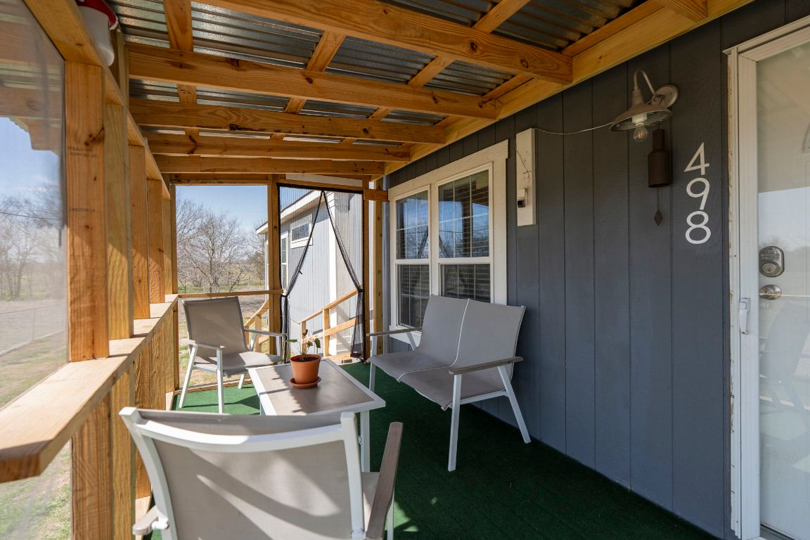 498 William Pettus Road Maxwell, TX 78656 - Photo 20 of 27 a porch area with table and chairs