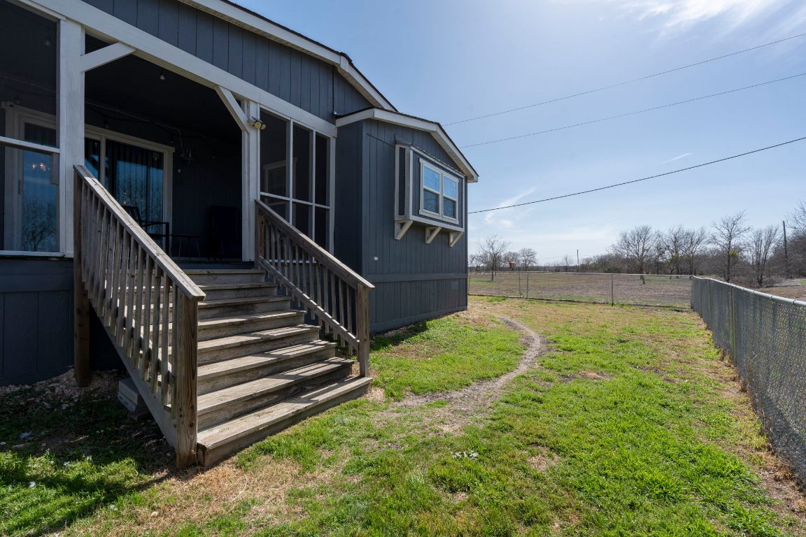 498 William Pettus Road Maxwell, TX 78656 - Photo 22 of 27 a view of a house with backyard and wooden fence