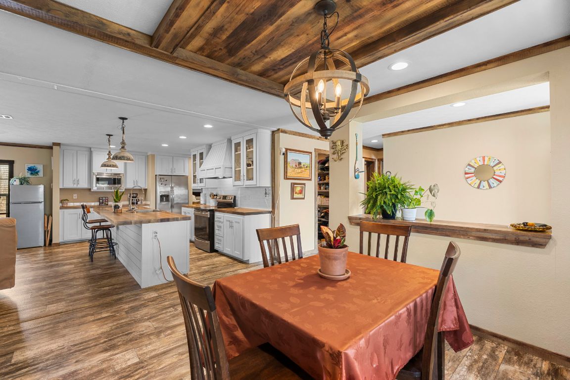 498 William Pettus Road Maxwell, TX 78656 - Photo 5 of 27 a view of a dining room with furniture a chandelier and wooden floor