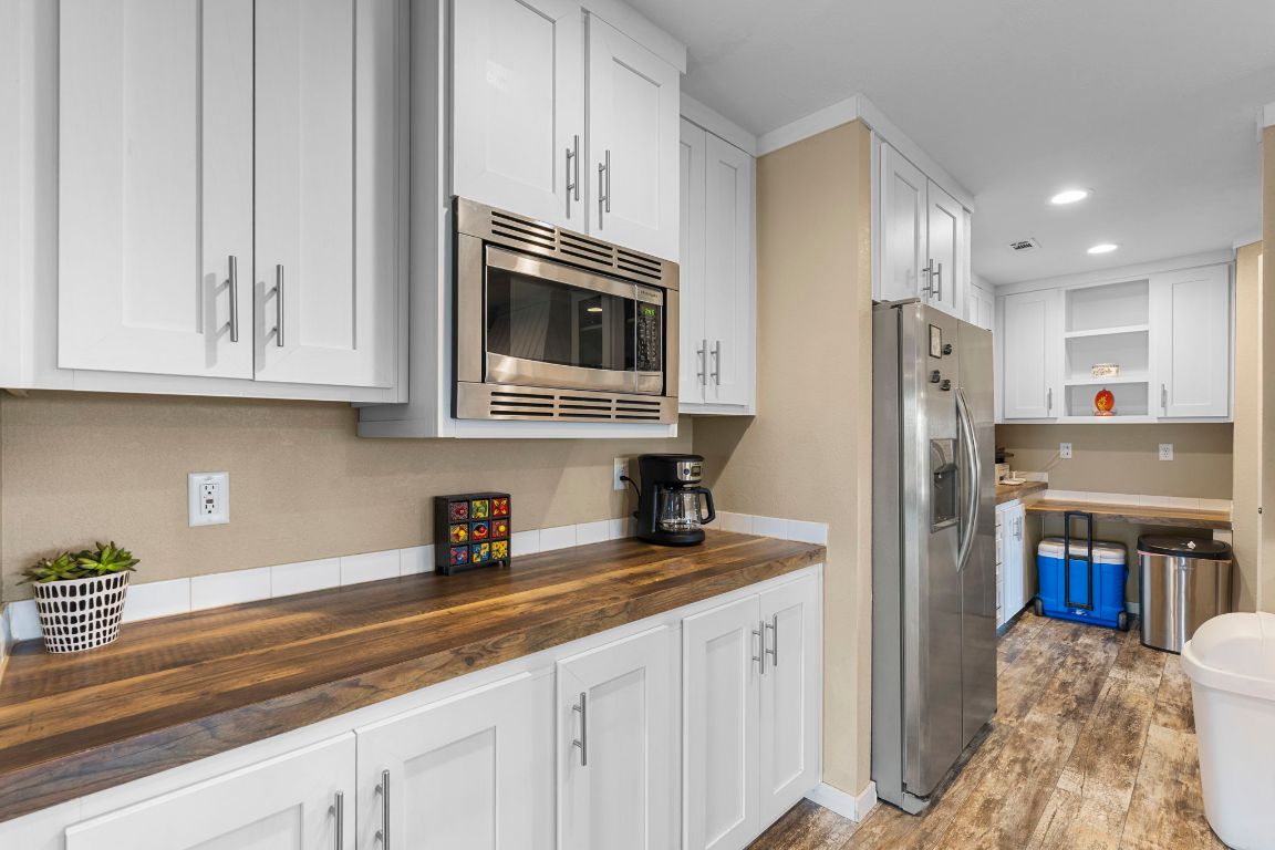 498 William Pettus Road Maxwell, TX 78656 - Photo 7 of 27 a kitchen with stainless steel appliances granite countertop a refrigerator sink and microwave