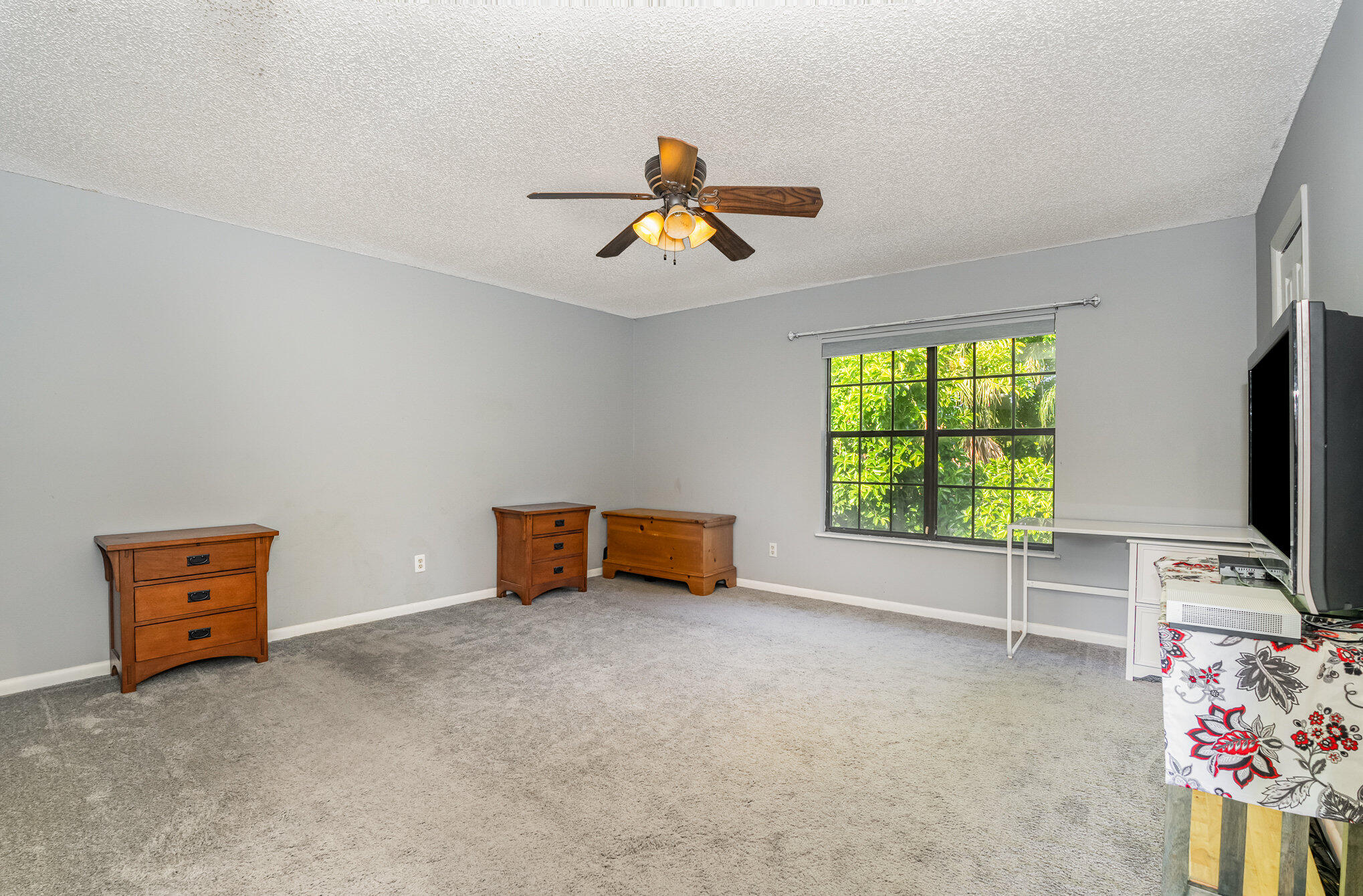 3118 Manor Drive Northeast Palm Bay, FL 32905 - Photo 11 of 22 an empty room with windows and a flat screen tv