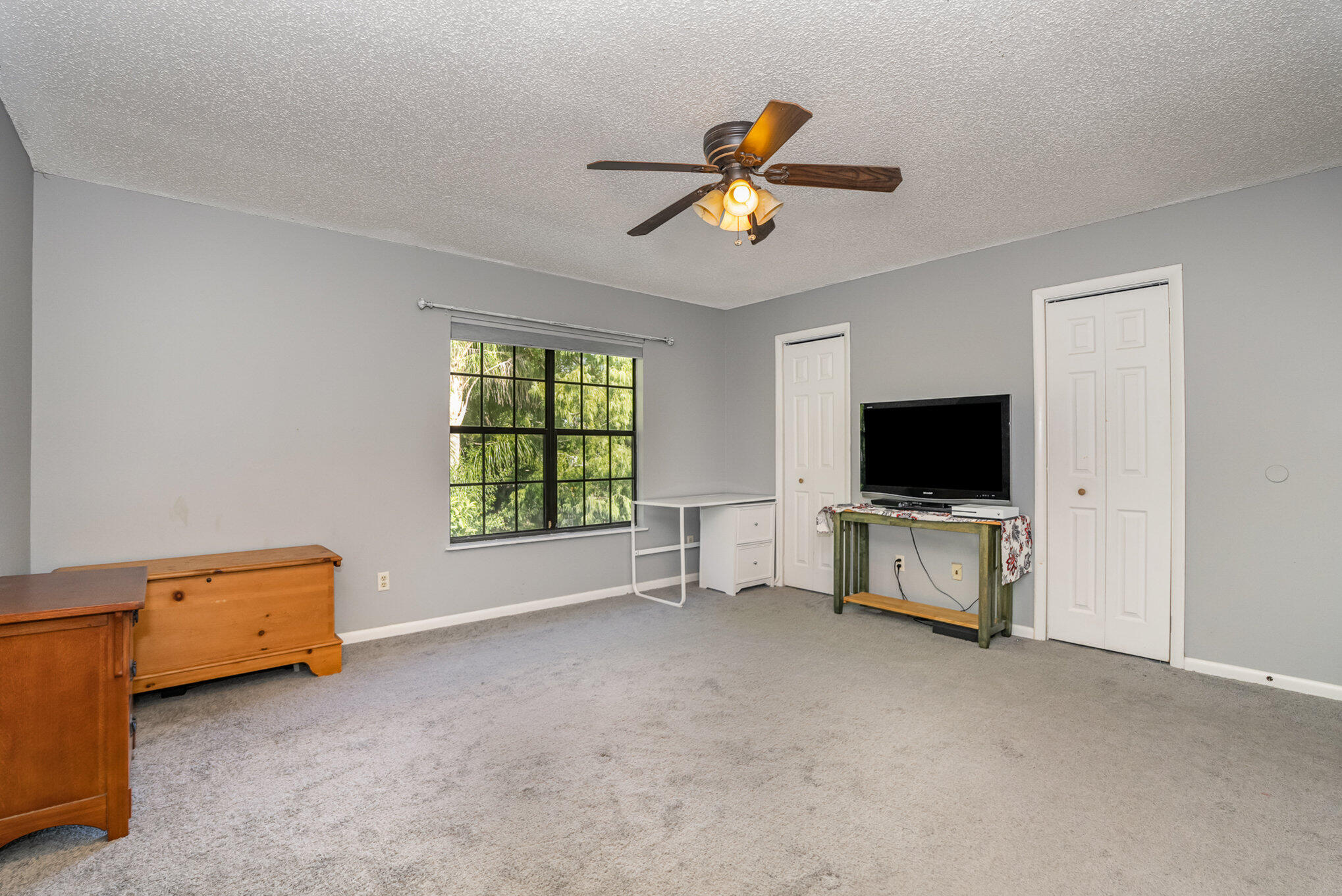 3118 Manor Drive Northeast Palm Bay, FL 32905 - Photo 12 of 22 a view of a livingroom with furniture and a flat screen tv