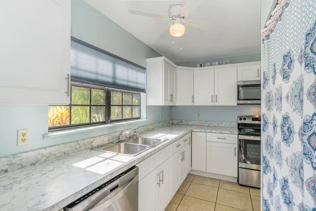 a kitchen with a sink stove and cabinets