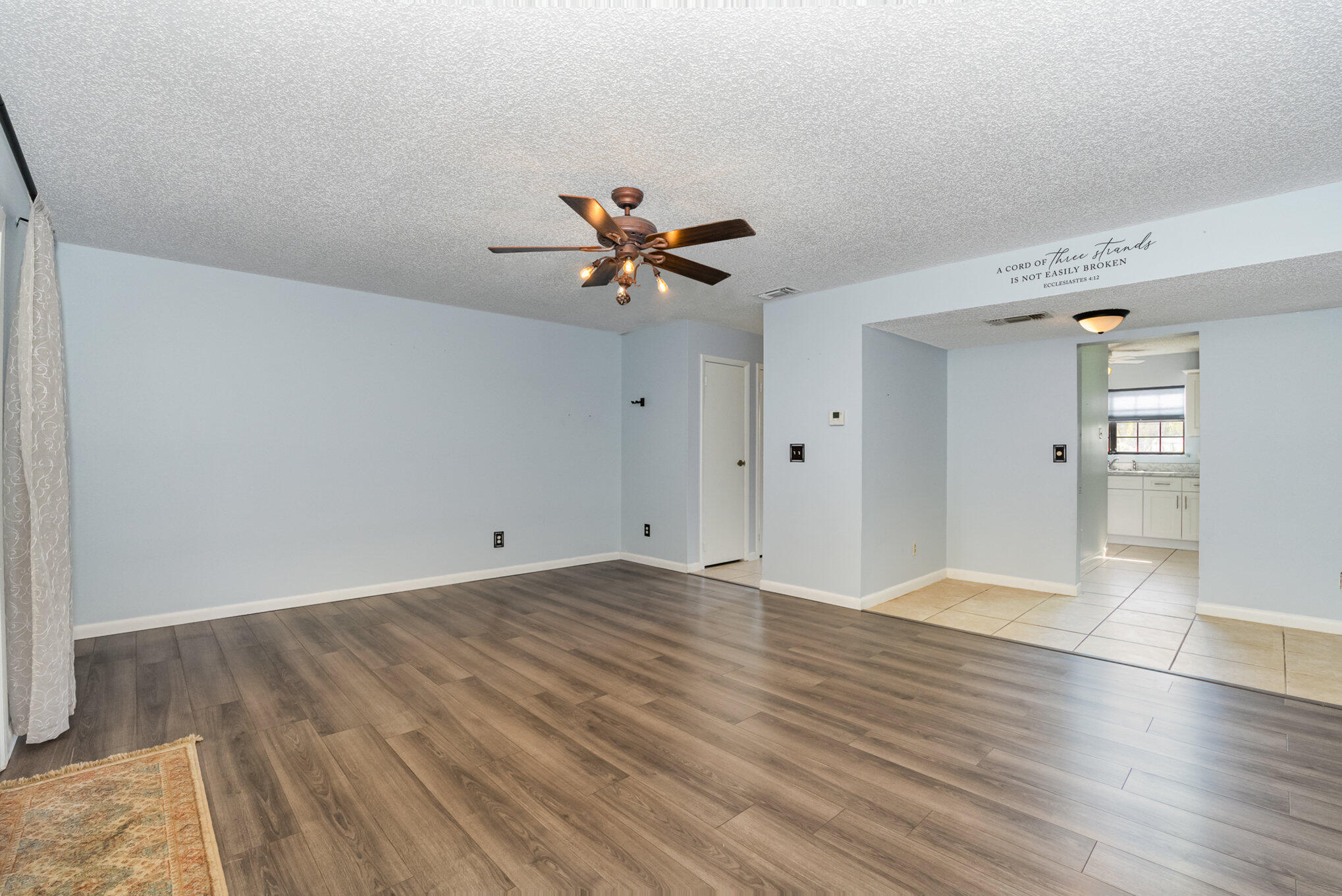 3118 Manor Drive Northeast Palm Bay, FL 32905 - Photo 7 of 22 wooden floor in an empty room with a window