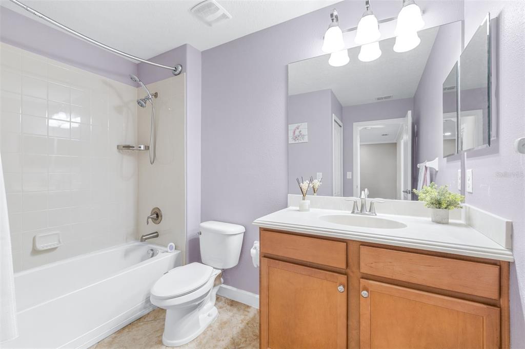 1762 Hadden Hall Place Trinity, FL 34655 - Photo 29 of 49 a bathroom with a sink a toilet a mirror a bathtub and shower