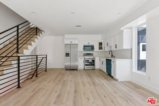 a view of a room with furniture and wooden floor