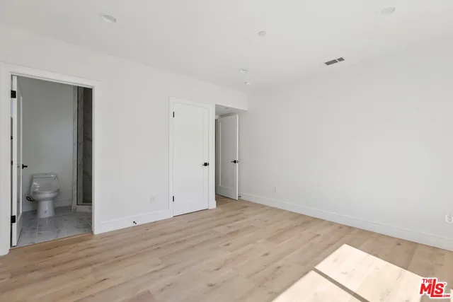 a bathroom with a toilet a sink and a mirror