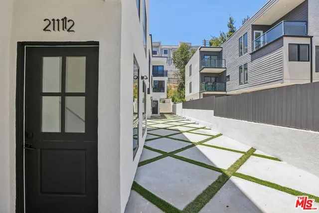 a view of a brick house with a door and a window