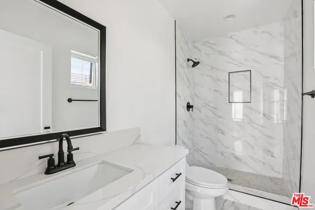 a bathroom with a toilet sink and shower