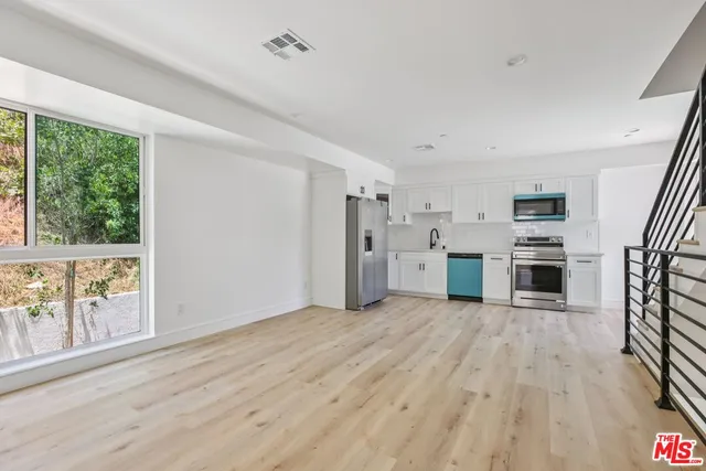 a view of a hallway with a closet and a window