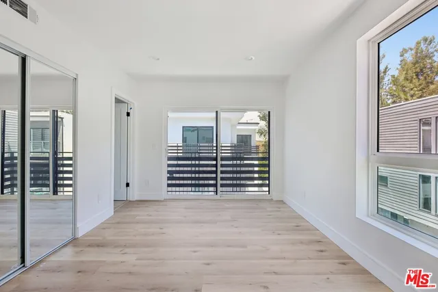 a view of a balcony with wooden floor and fence