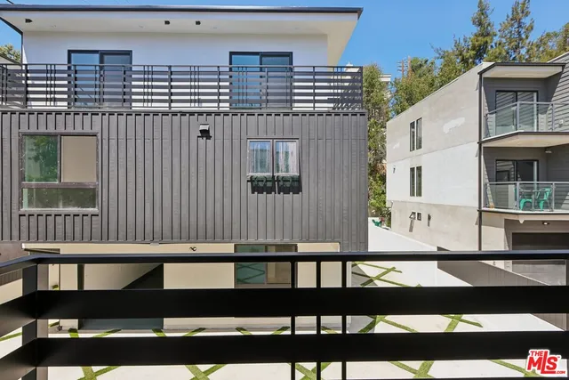 a view of a house with wooden deck