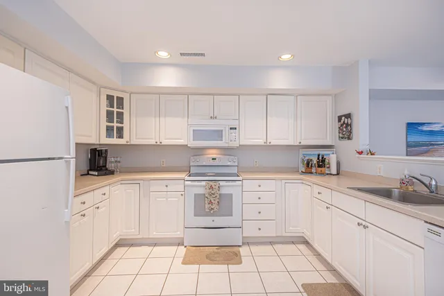 a kitchen with refrigerator and cabinets