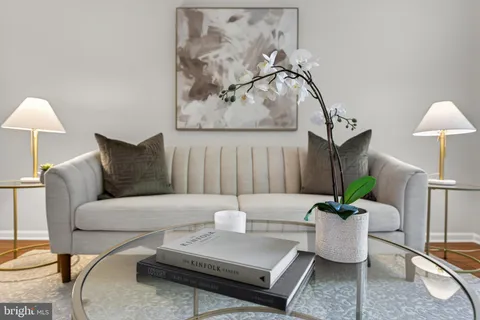 a living room with furniture and a lamp