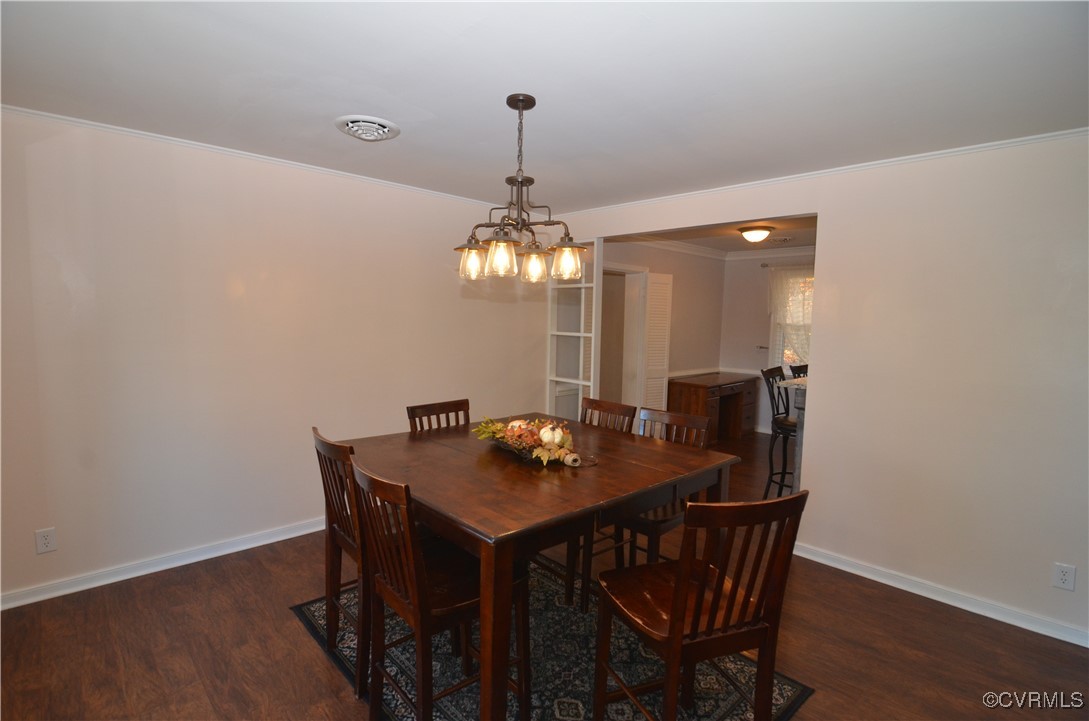 9712 Esmont Road Henrico, VA 23228 - Photo 8 of 21 Dining area featuring crown molding, dark wood-typ