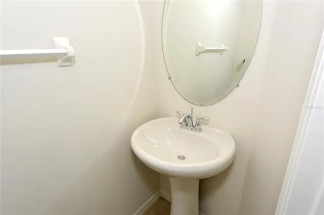 a bathroom with a sink and mirror