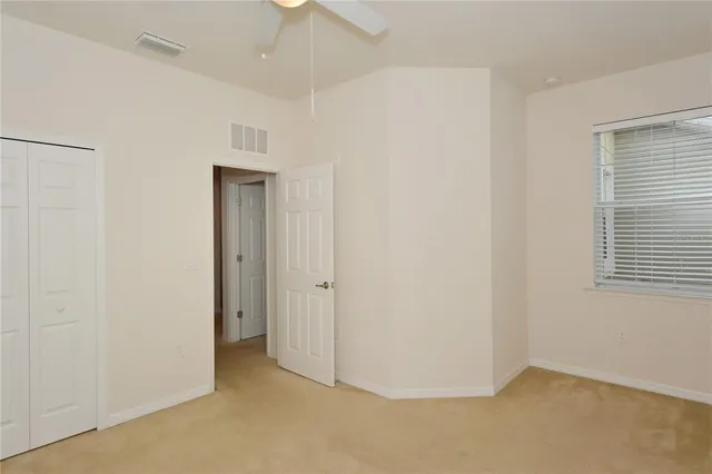 an empty room with kitchen view