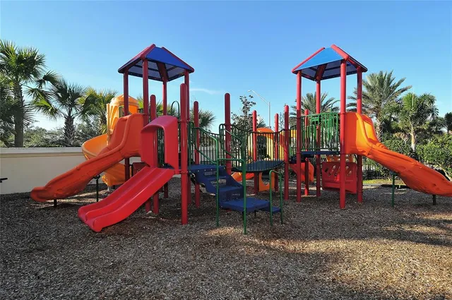 a backyard of a house with fire pit and chairs