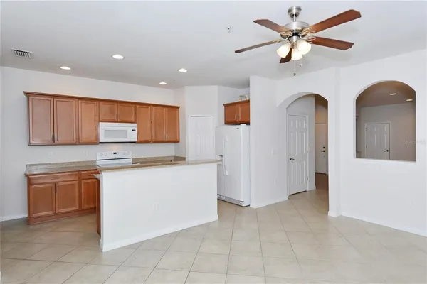 a living room with stainless steel appliances kitchen island granite countertop furniture and a view of kitchen