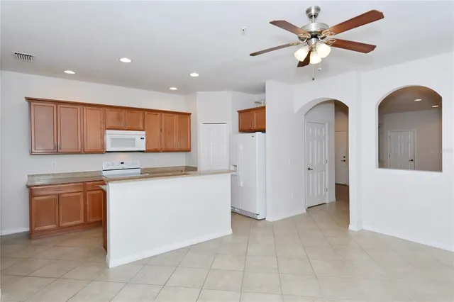 a living room with stainless steel appliances kitchen island granite countertop furniture and a view of kitchen