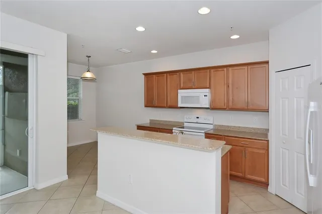 a kitchen with a sink a stove and cabinets