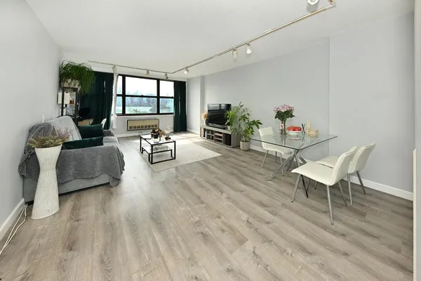 a living room with furniture and a wooden floor