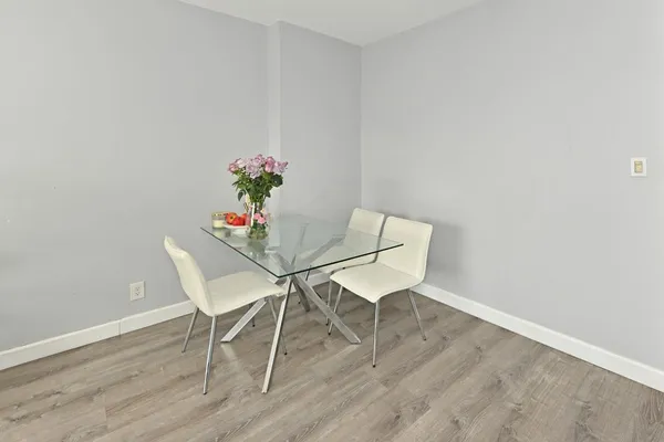 a dining room with furniture and wooden floor