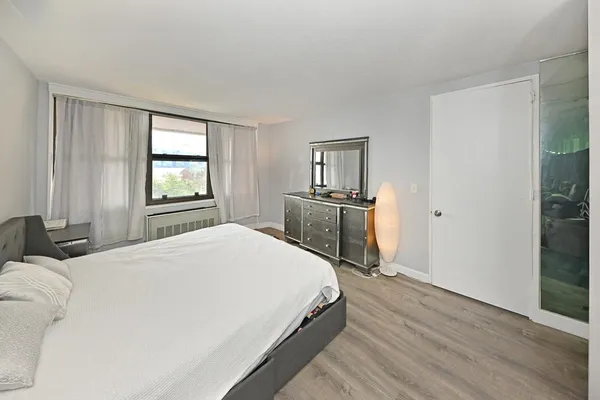 a spacious bedroom with a bed and large windows