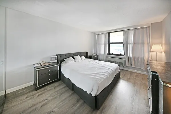 a bedroom with a bed and a window