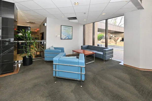 a living room with furniture a flat screen tv and a large window