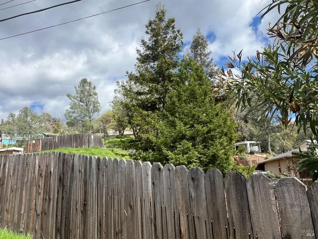 a view of a pathway of a wooden fence