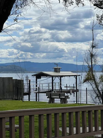 a view of backyard of white apartments with outdoor seating