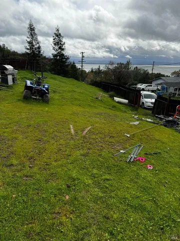 a view of a green field with sitting area