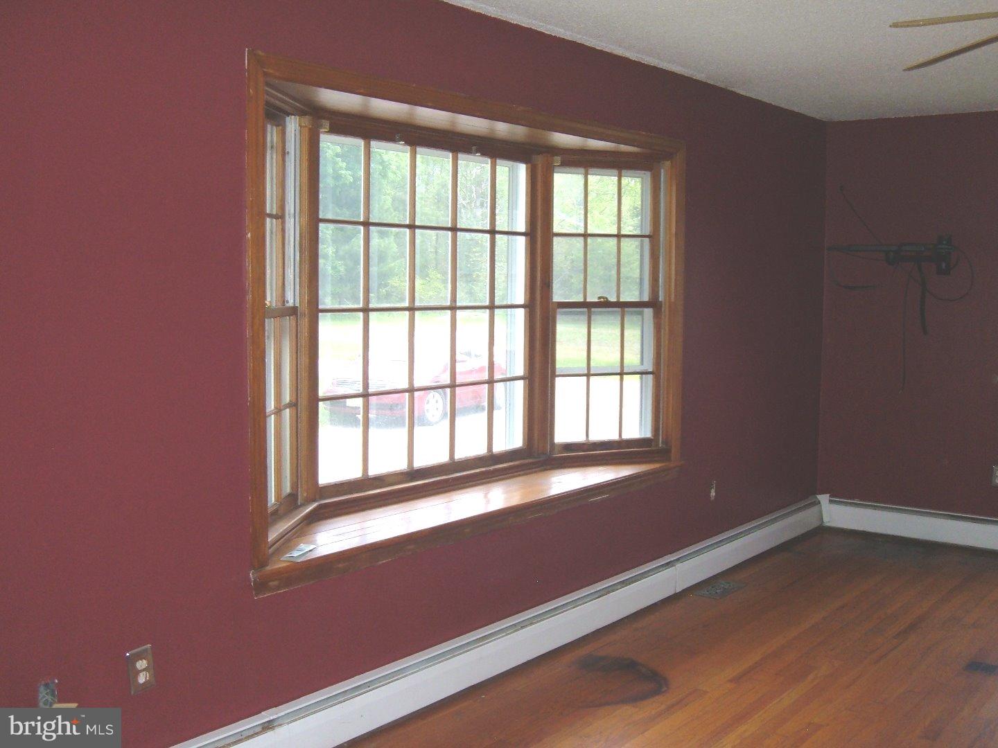 114 Scrapetown Road Pemberton, NJ 08068 - Photo 3 of 23 a view of an empty room with wooden floor and a window