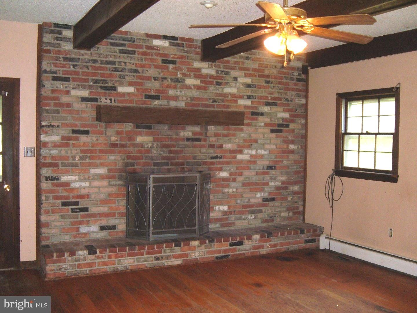 114 Scrapetown Road Pemberton, NJ 08068 - Photo 6 of 23 a room with a fireplace and wooden floor