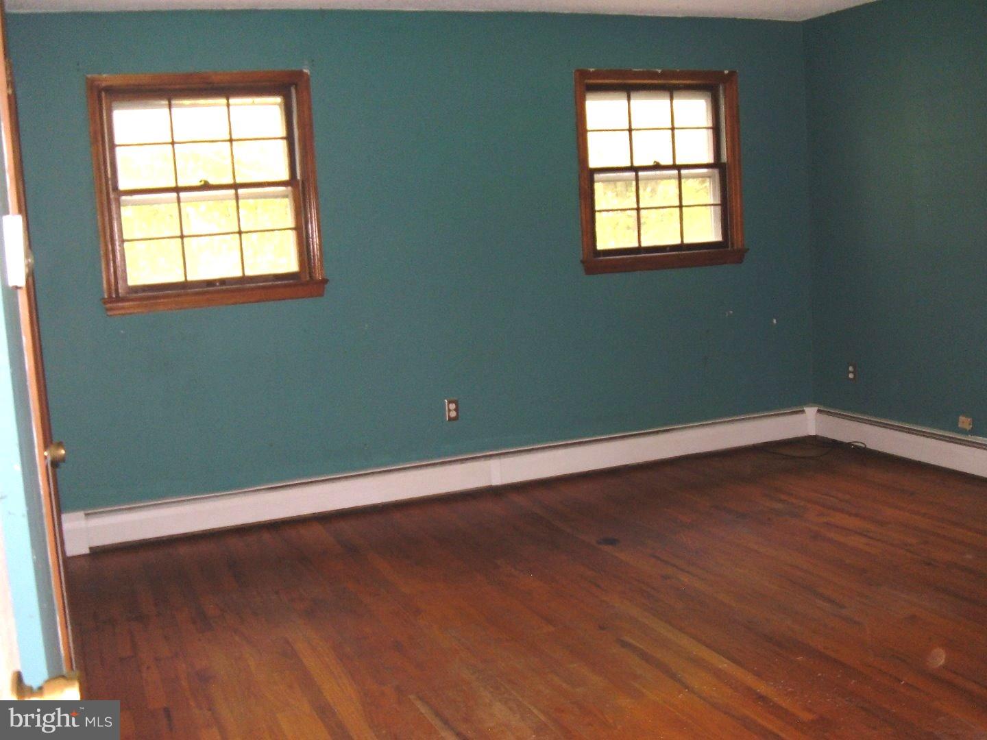114 Scrapetown Road Pemberton, NJ 08068 - Photo 7 of 23 an empty room with wooden floor and windows