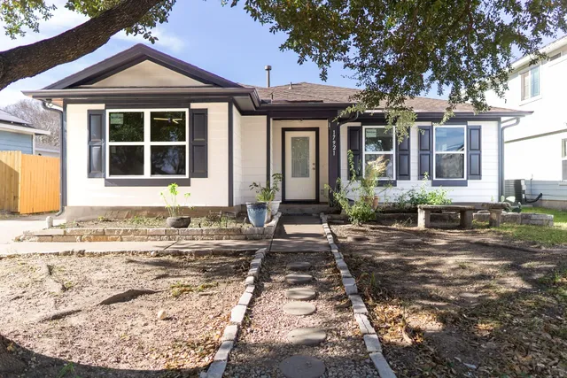 a front view of a house with garden