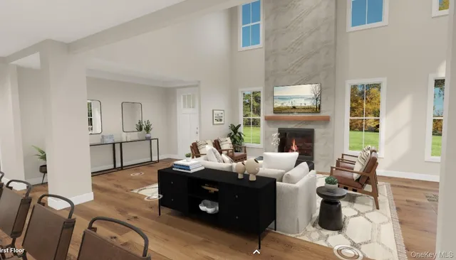 a living room with furniture fireplace and a large window