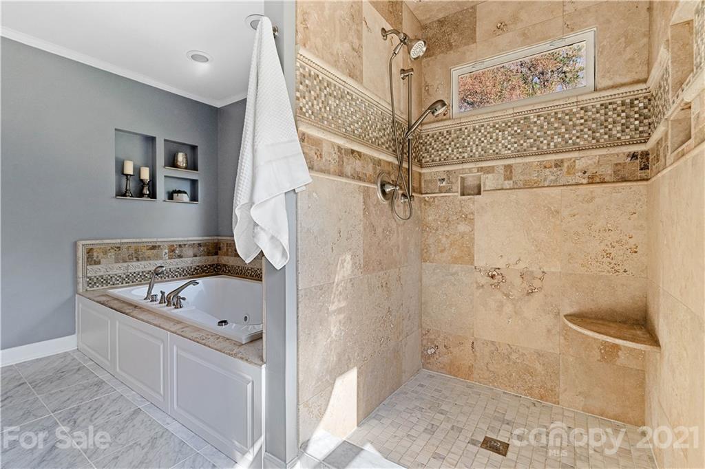 8866 Collins Road Indian Land, SC 29707 - Photo 23 of 48 a bathroom with a tub a sink and glass door
