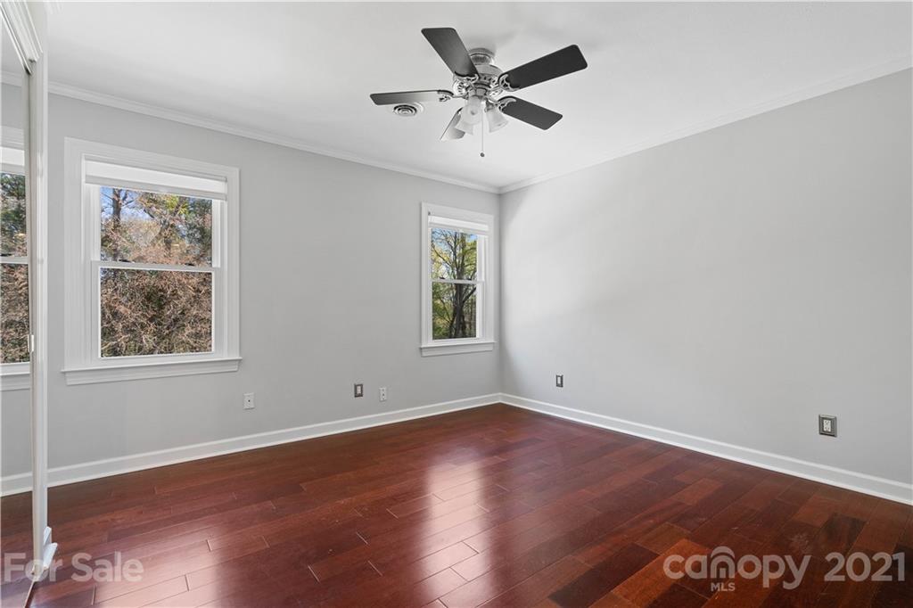 8866 Collins Road Indian Land, SC 29707 - Photo 24 of 48 a view of an empty room with wooden floor and a window